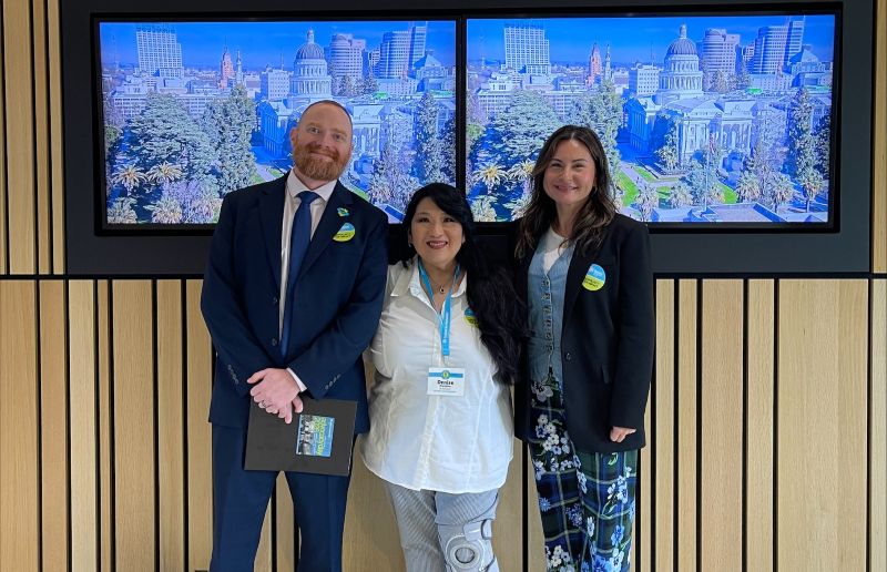 3 people smiling and posing for the camera
