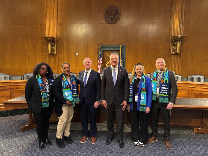 6 people smiling and posing for the camera