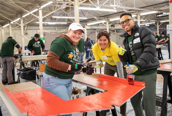 Group of three volunteers smiling into the camera
